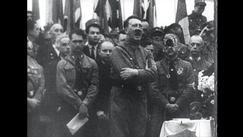 1950s: Adolph Hitler speaking into microphone.