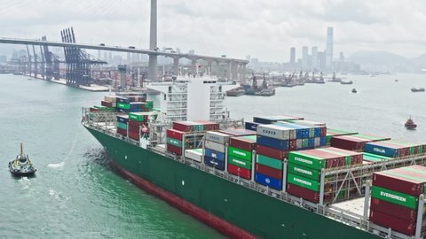 Hong Kong, Hong Kong - Jul 8, 2019: Cargo ship transporting shipment container arriving Hong Kong port, drone aerial view. Freight transportation, import export business or industrial concept