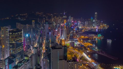 night illuminated flight over hong kong city downtown traffic bay aerial panorama 4k timelapse