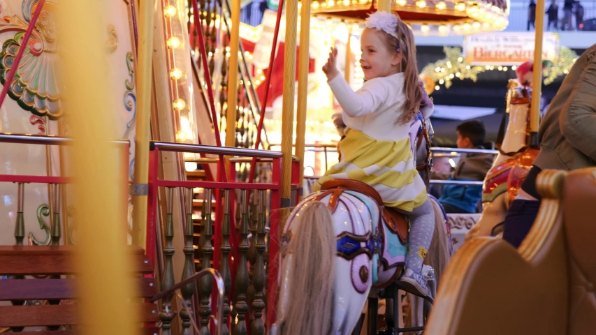 Close up interior view inside moving Carousel, roundabout or merry-go-round surround with colourful retro vintage wooden seat and horses move up and down, and atmosphere of amusement park.  | Shutterstock HD Video #1033957613