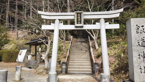 Koka, Shiga / Japan - 03 23 2019: Koka, Shiga Prefecture, Japan March 23rd 2019- Slow Slide shot to Stone Torii Gate at Shirohige Shrine in Japan