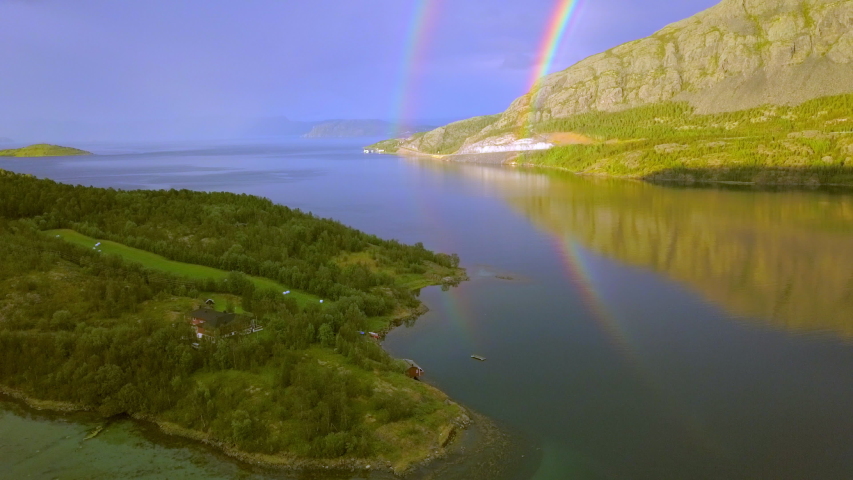 The reflection of the two rainbows on the beach in Norway found on the end of the mountain