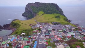 Aerial video of Seongsan Ilchulbong with sunrise in the morning time, Jeju island South Korea.