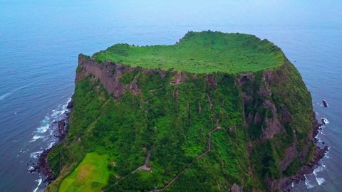 Aerial video of Seongsan Ilchulbong with sunrise in the morning time, Jeju island South Korea.
