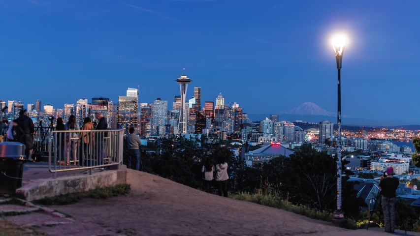 Illuminated City Buildings in Seattle Skyline Hyperlapse with Crowd Blur at Popular Park