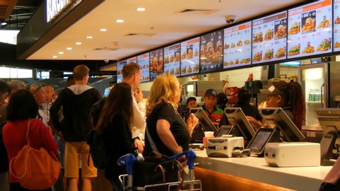 Amsterdam, Netherlands - April 24, 2019: Fast food restaurant near which the line of hungry tourists. Burger King at Schiphol Airport