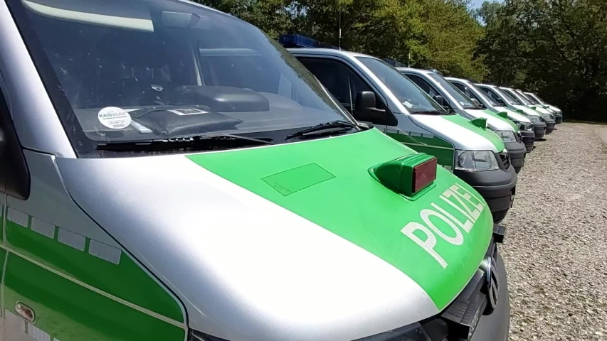 Panorama of a row of Parking Bavarian, German green Police Buses  (Polizeibus). Major Police Unit in operation.
