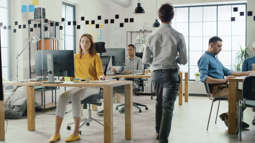In the Stylish Open Space Office: Diverse Group of Enthusiastic Business Marketing Professionals Use Computers, Have Meetings, Discussing Project Ideas, Brainstorming Startup Company Strategy | Shutterstock HD Video #1033983044