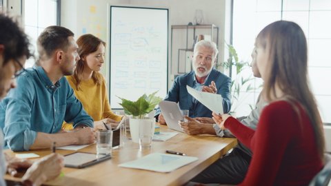 Startup Executive Director Leads Company's Daily Meeting with a Speech, Questions Employees, Analytics and Specialists. CEO Looks at Documents, Gives Philisophical Advice to Workers