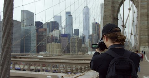 Handsome Male Model Photographing Beautiful Brooklyn Bridge And Iconic New York Skyline With Incredible NYC Skyscrapers