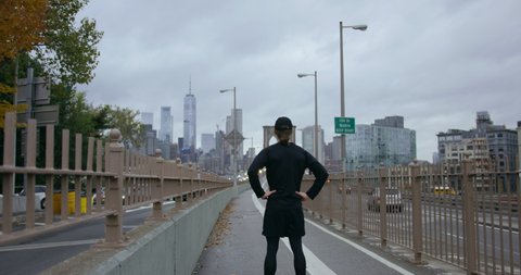 Runner Standing With Classic New York Traffic With Incredible Skyscrapers On Classic New York Road Towards Brooklyn Bridge In Beautiful NYC with Autumn Trees