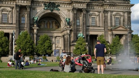 Berlin, Germany - July, 2019: Many people on touristic hotspot at Berlin Cathedral enjoying sunny weather in public park showing City life of Berlin during summer  