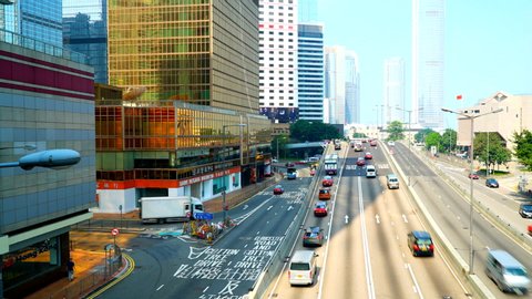 Hong kong, China - 04 08 2019: Hong kong - Circa Moving time lapse view of bustling downtown Hong Kong on a bright afternoon. Heavy traffic on the roads filled with cars and buses. Modern architecture