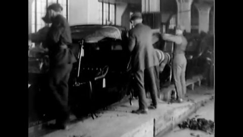 CIRCA 1923 - Ford car bodies are assembled at a plant.