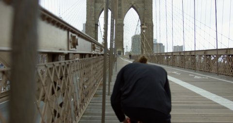 Athletic Runner Preparing To Exercise On Beautiful Brooklyn Bridge With Impressive New York Skyline 