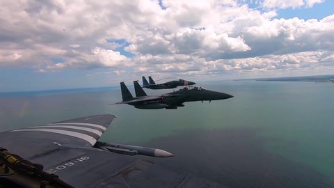 CIRCA 2019, - F-15 aircraft perform a "missing man" formation over Omaha Beach in honor of the 75th anniversary of D-Day, June 6, 2019