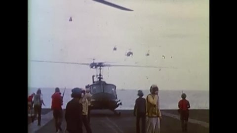 CIRCA 1975 - Helicopters bring South Vietnamese refugees to the flight deck of the USS Midway.