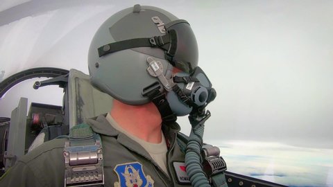 CIRCA 2010s - Cockpit view of a pilot as he makes visual communication with another pilot mid flight, Red Flag 19-1 exercise, Nellis Air Force Base.