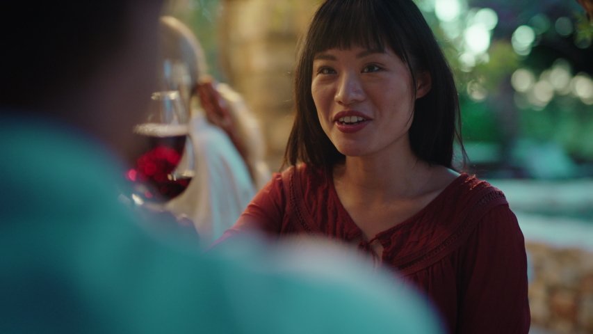 beautiful asian woman enjoying dinner date flirting with man couple drinking wine making toast celebrating romantic evening together 4k Royalty-Free Stock Footage #1034005007