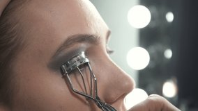 Video of visagist using eyelash tongs