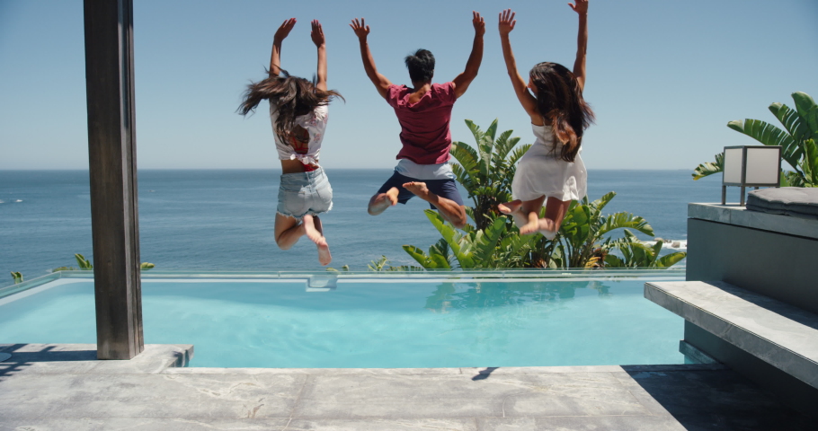 Fun friends jumping in swimming pool at luxury hotel resort celebrating summer vacation enjoying sunny day on travel holiday 4k | Shutterstock HD Video #1034006237