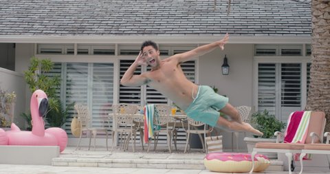 cool funny man jumping in swimming pool excited for summer having fun splashing in water enjoying summertime swim on vacation 4k
