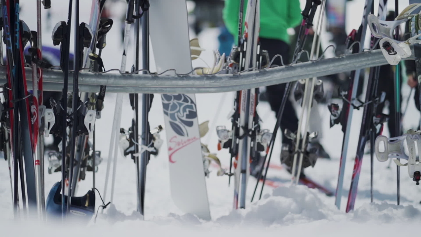 Yosemite, CA / United States - 03 29 2019: Slow motion shot of skis and snowboard on rack in snow. | Shutterstock HD Video #1034018762