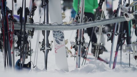 Yosemite, CA / United States - 03 29 2019: Slow motion shot of skis and snowboard on rack in snow.