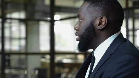 Afro-american man worrying about dismissal, racial discrimination at work