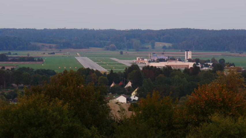 Little airplane on approach to land on a small regional airport in Augsburg, Bavaria, Germany in the evening hours.