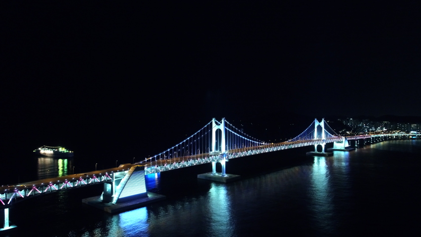 It is a night view of aerial photography in Busan, South Korea. The night view of Busan is beautiful and the connection to the Diamond Bridge is a wonderful sight. The night view of the landmark build