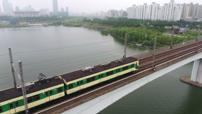 The subway is passing over the Dangsan Railroad Bridge in Seoul, Korea. The bridge connects downtown Seoul.