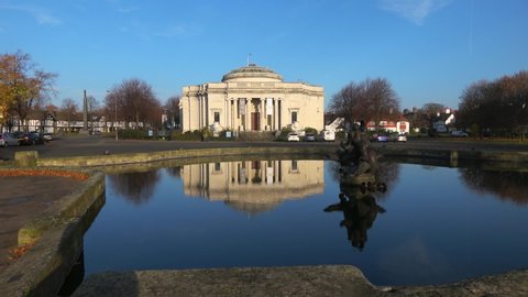 Liverpool, United Kingdom (UK) - 11 18 2018: Zoom in on The Lady Lever Art Gallery, Port Sunlight with the building reflected in the pond on a sunny day with a blue sky in the background.