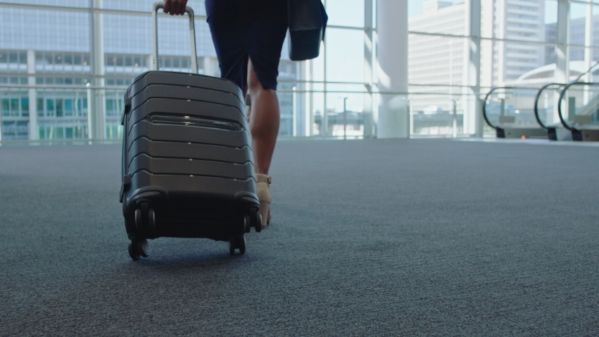 business woman traveler walking in airport with trolly bag going up escalator female executive traveling international for business trip checking messages on smartphone 4k Royalty-Free Stock Footage #1034047667