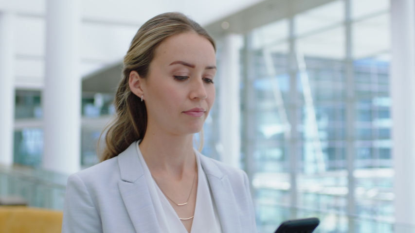 Beautiful business woman using smartphone texting walking in corporate office typing text messages on mobile phone checking emails successful female executive at work 4k footage | Shutterstock HD Video #1034048405