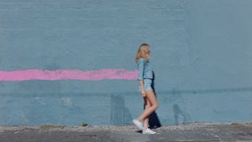 Graffiti girl artist woman painting wall with pink paint walking in city street confident rebellious female enjoying artistic expression with urban graffiti art - Powered by Shutterstock - Get 15% off with code: PIKWIZARD15