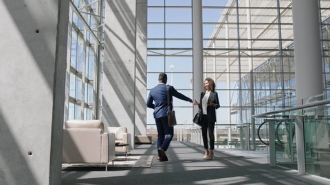 business people shaking hands african american businessman meeting female colleague in corporate office greeting with handshake welcoming client 4k