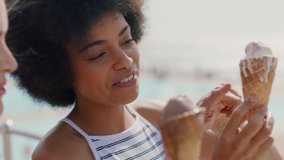 beautiful women eating ice cream on beach girl friends enjoying delicious soft serve relaxing on warm summer day 4k footage - Powered by Shutterstock - Get 15% off with code: PIKWIZARD15