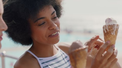 beautiful women eating ice cream on beach girl friends enjoying delicious soft serve relaxing on warm summer day 4k footage