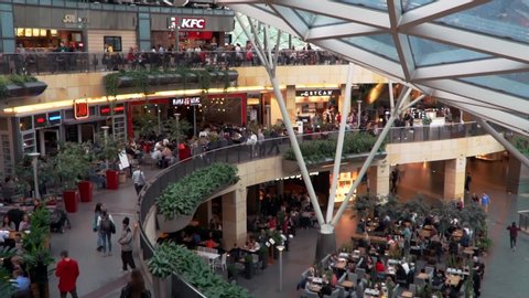 Warsaw, Poland - 04 08 2019: People sitting at the food court inside the Zlote Tarasy shopping center in Warsaw.