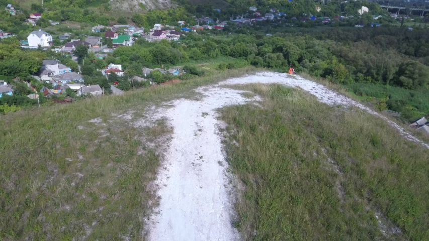 Beautiful spring and summer landscape. Mountain country road among green hills. Lush green hills, high mountains. Spring flowering grass. Summer natural background.