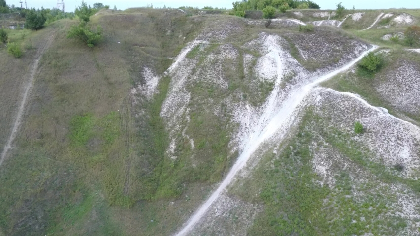 Beautiful spring and summer landscape. Mountain country road among green hills. Lush green hills, high mountains. Spring flowering grass. Summer natural background.