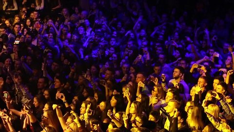 MOSCOW-22 FEBRUARY,2017:Rap concert audience partying to live performance of Russian hip hop band Miyagi & Endshpiel in Glavclub nightclub.Crowd of young people wave hands and sing songs in the club