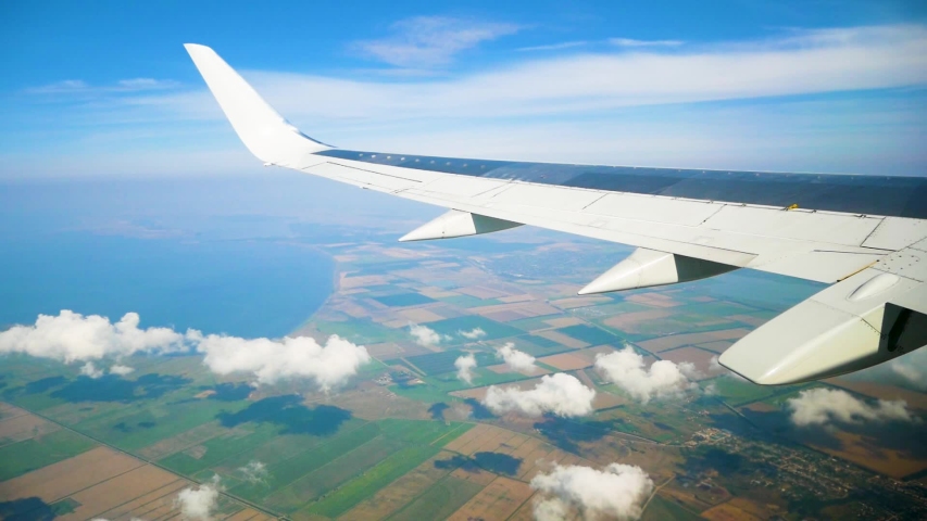 Plane taking off from airport, View through an airplane window | Shutterstock HD Video #1034058902