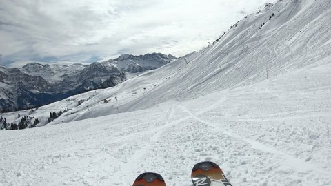 Morzine-Avoriaz, Savoie / France - 03 13 2019: Low angle POV shot skiing down a slope at a ski resort.