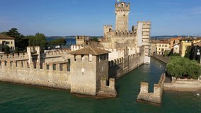 Flight by a drone, aerial view of Rocca Scaliger Castle in Sirmione. Lake Garda. Italy.