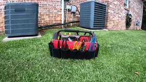 4k Video of home HVAC Air Conditioner with maintenance tool bag.