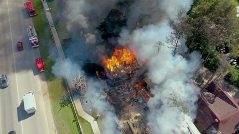 big fire and black smoke shooting from a height. 4K footage from drone