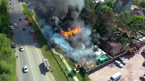 Aerial view of a live fire training exercise with a fully involved house. 4K footage from drone