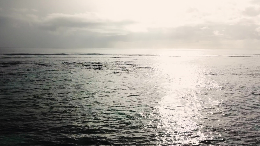 Reef waves breaking at dusk